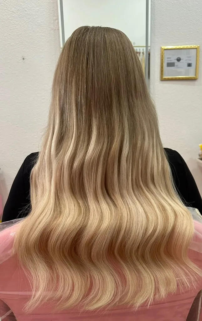 Long blonde hair extensions with soft waves