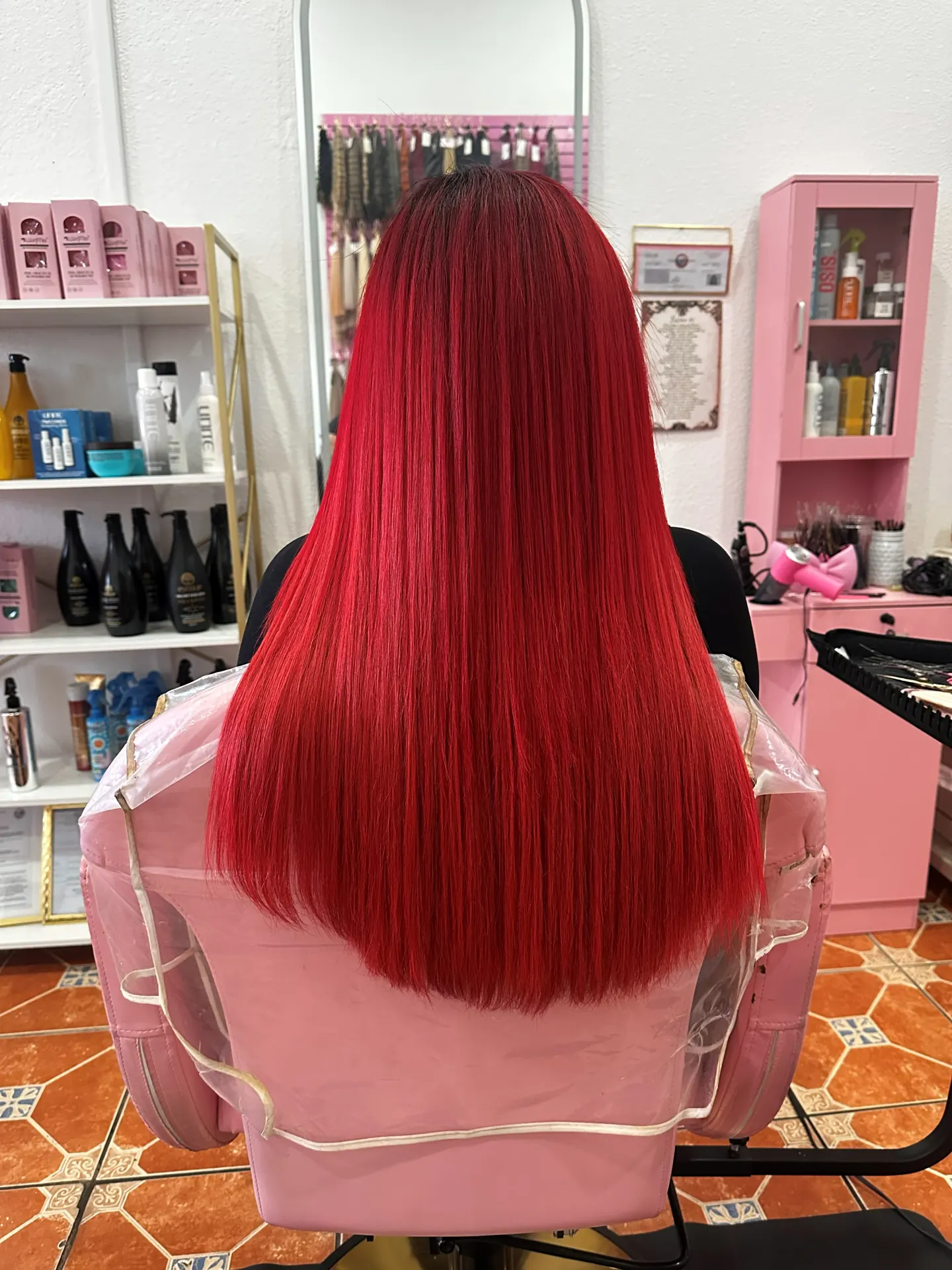 Bright red hair after nano-tip extensions at Concept Beauty Studio